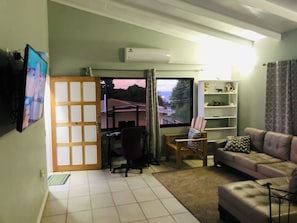 Deluxe Apartment | Living area | TV