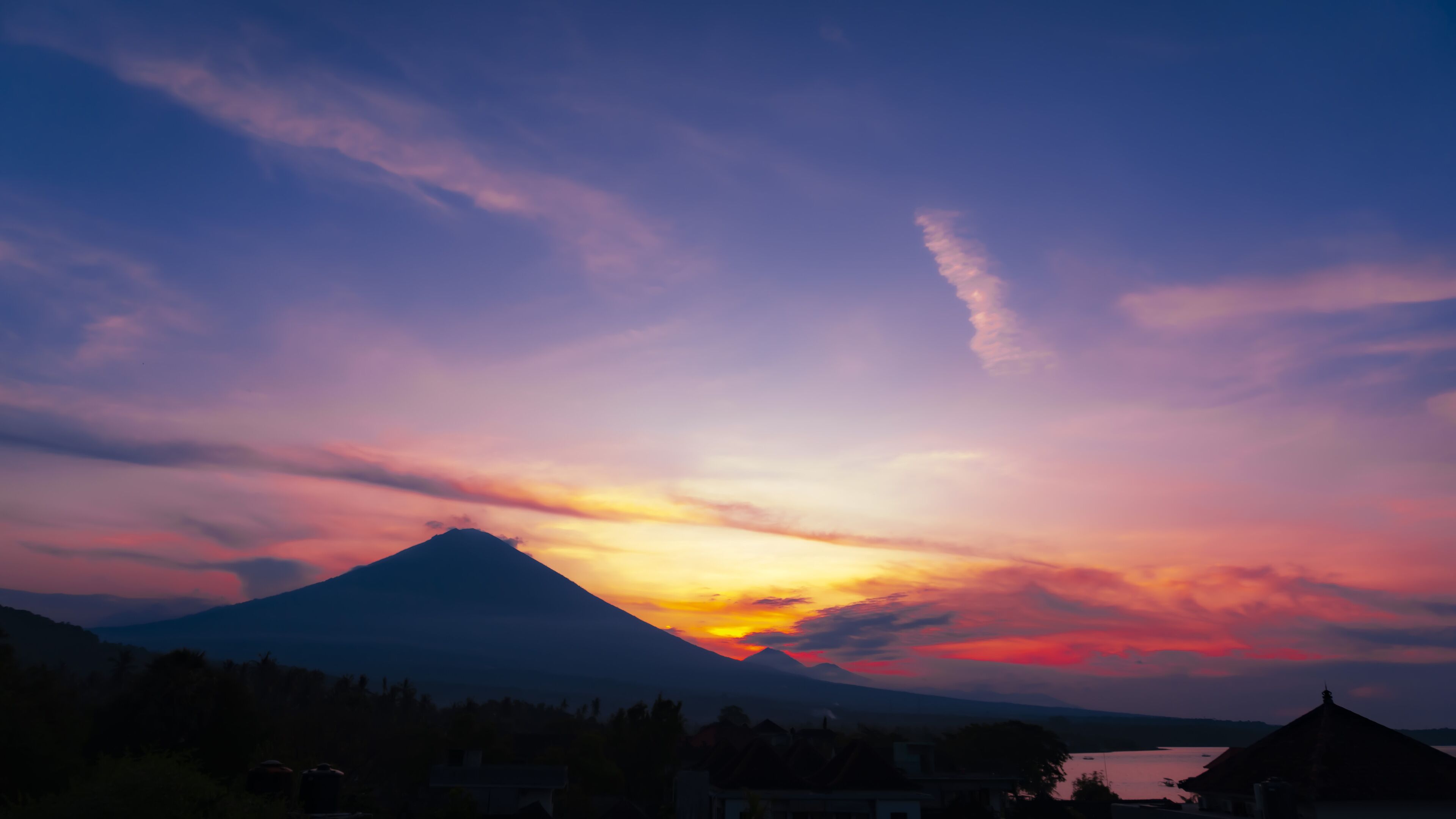 A mountain with a sunset in the background.