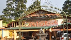 A restaurant named CheTica Ranch with a decorative fountain in the center. - Mountain Lodge CheTica (San Jeronimo)