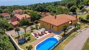 A residential property with a swimming pool, sun loungers, and a trampoline. - Awesome home in Opric (Opric)