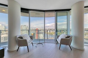 Enjoy a panoramic city view from the comfort of this stylish room, featuring floor-to-ceiling windows and a minimalist design.