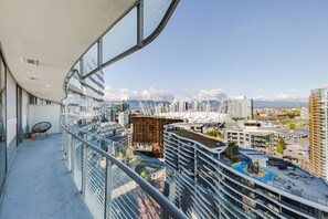 Enjoy expansive city views from the balcony with a seating area.