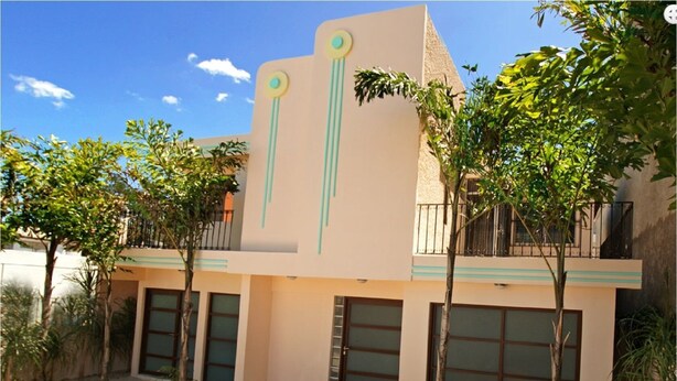 A modern building with a flat roof, two balconies, and a garage entrance. - FOG HOUSE (Cancun)