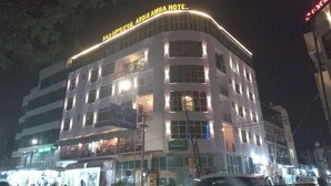 A multi-story hotel with illuminated signage reading "Addis Ambai Hotel." - Addis Amba Guest House (Addis Ababa)