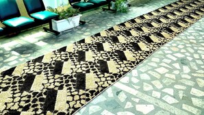 A waiting area with chairs and a patterned carpet. - Addis Amba Guest House (Addis Ababa)