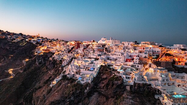 A coastal town with white buildings, steep cliffs, and a clear view of the sea. - Three-Bedroom Villa with Caldera View, Heated Jacuzzi Pool and  Breakfast (Thera)