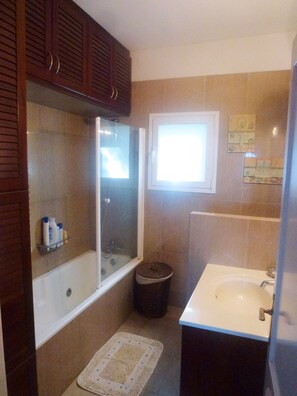 Combined shower/tub, hair dryer, towels, toilet paper