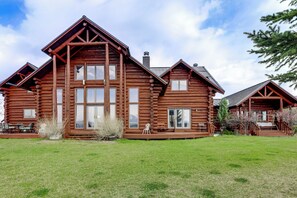 A large log cabin with multiple windows, a porch, and a well-maintained lawn. - Hot Tub & Views! 8,000-Sq-Ft Glenwood Springs Gem (Glenwood Springs)