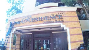 The exterior of a building with a sign that reads "The Residence" and "Jordanian Beach".
