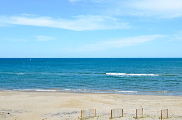 A beach with a sandy shore and a clear blue sky. - 6193- Beech Nut - OBX Oceanfront Nags Head Family Escape (Nags Head)
