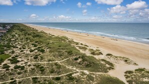 Een strand met een heldere lucht en een zandstrand.