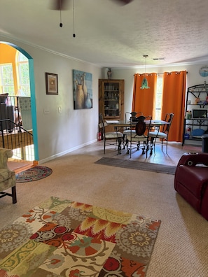 A living room with a dining area, a fireplace, and a view of the outdoors. - Come enjoy fishing, R&R or visit with family come visit! (LaGrange)