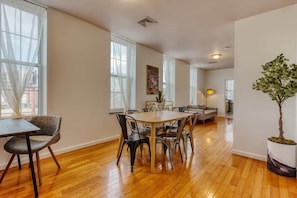 Relax in this spacious living area with a dining table for six, surrounded by comfortable chairs.