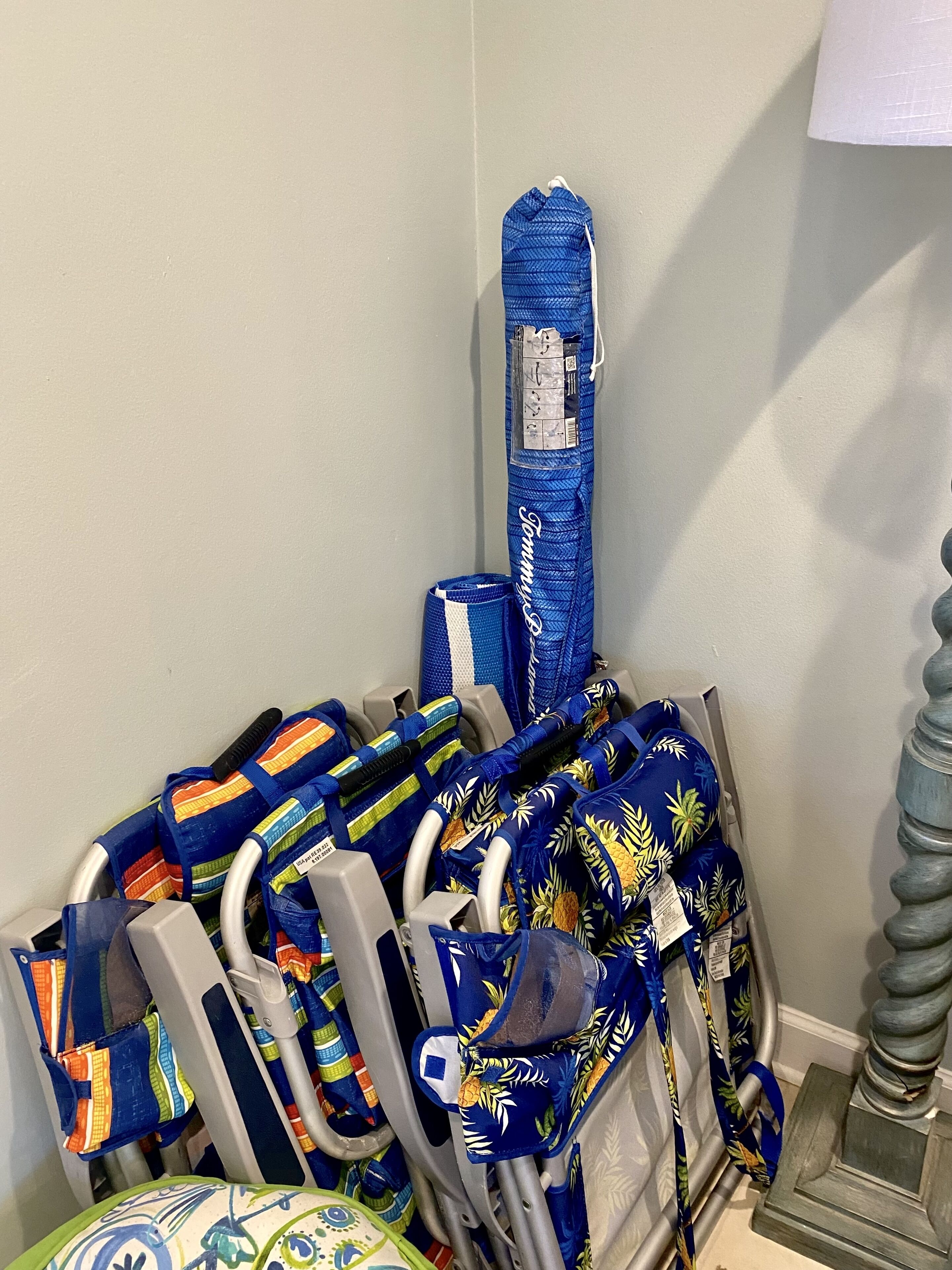 A storage area with various bags and a blue Tommy Hilfiger bag.