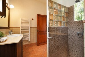A bathroom with a sink, towel, and shower. - Charming House - 6 pax, - Wifi Free - Sat TV - Private Salat Pool (Manacor)
