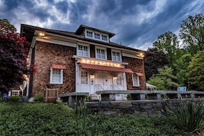 A two-story brick building with a red awning and a sign that reads "Ivoryton Playhouse". - Connecticut Colonial with River and Sunset Views! (East Haddam)