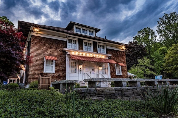 A two-story brick building with a red awning and a sign that reads "Ivoryton Playhouse".