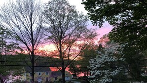 A residential area with a house, trees, and a sunset. - Connecticut Colonial with River and Sunset Views! (East Haddam)