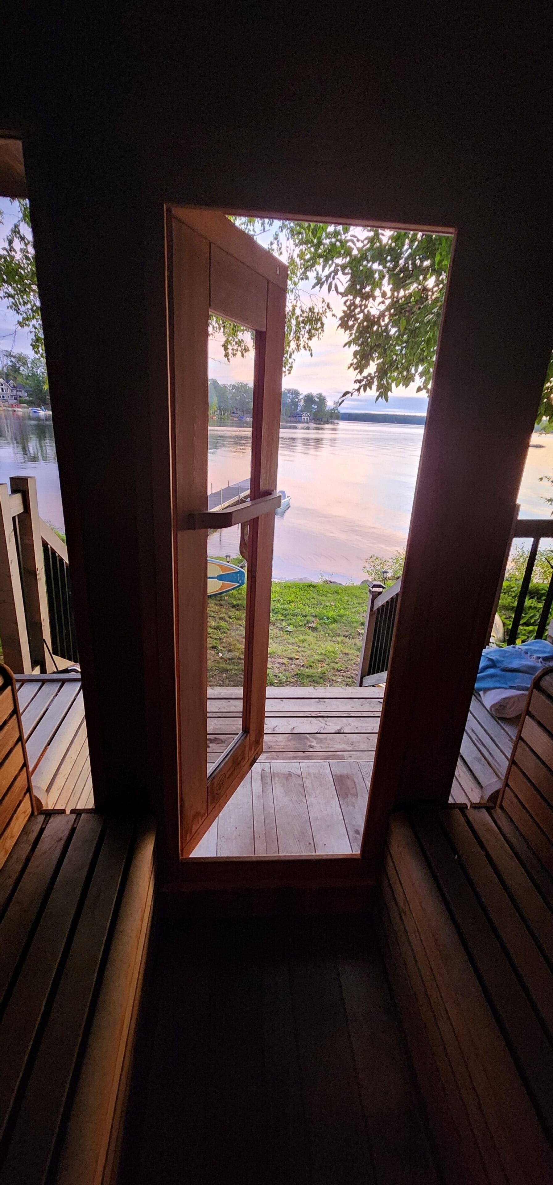 A wooden deck with a view of a body of water and a boat.