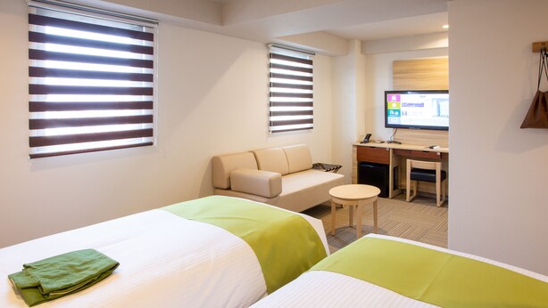A hotel room with two beds, a desk, a chair, and a television. - Kuretake Inn Premium Ogakiekimae (Ogaki)