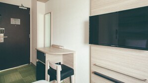 A hotel room with a bed, a desk with a chair, a television, and a wardrobe. - Kuretake Inn Premium Ogakiekimae (Ogaki)