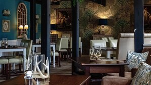 A dining area with tables, chairs, and a mural on the wall. - Blenkinsopp Castle Inn (Brampton)
