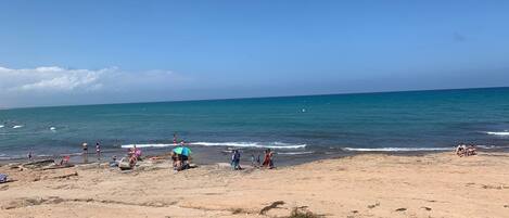 On the beach, sun-loungers, beach towels