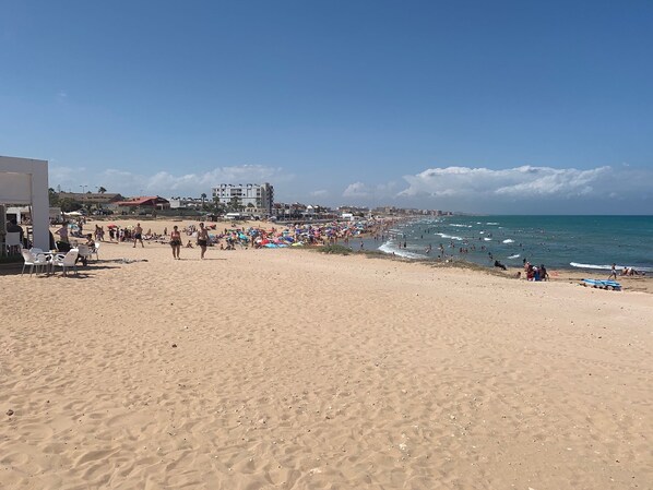 On the beach, sun loungers, beach towels