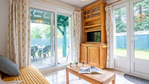 A cozy room with a sofa, a wooden table with a book, and a cabinet.