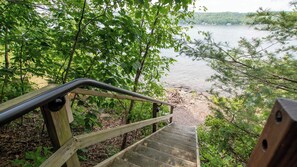 Stroll down to the lakeside area via the staircase, surrounded by lush greenery and trees.