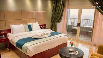 Deluxe Double or Twin Room, River View | In-room safe, desk, laptop workspace, blackout drapes