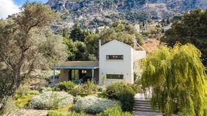 A modern house with a patio, surrounded by lush greenery and a mountain backdrop. - Tessera Villa, a Serene Escape in Nature with Pool (Spili, Rethymno)