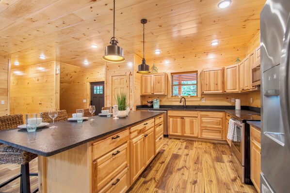 Enjoy cooking in this well-equipped kitchen with a large island and cabinetry.