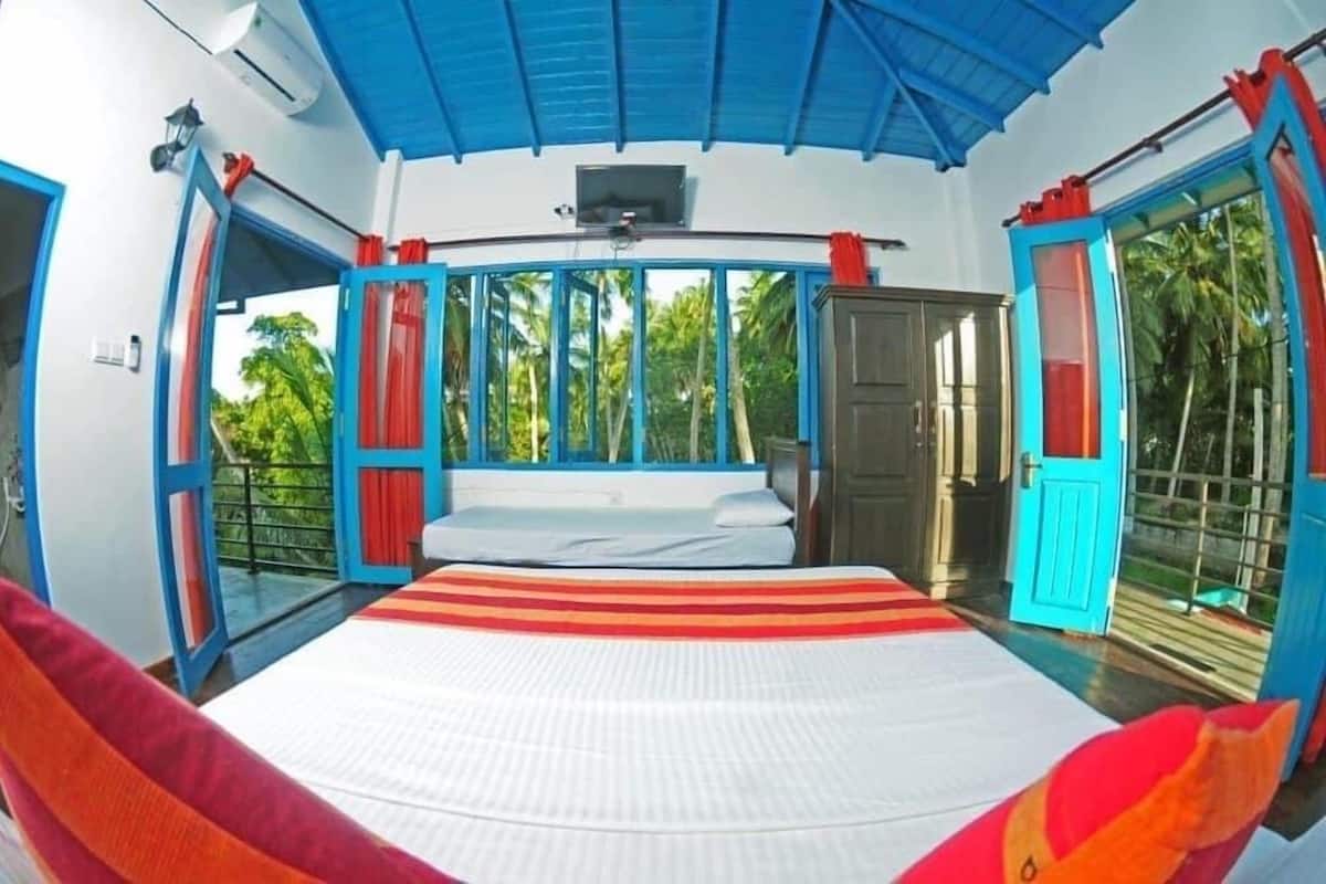 A room with a bed, a window, and a door.