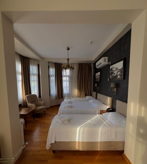 Family Quadruple Room | Minibar, laptop workspace, blackout drapes, soundproofing