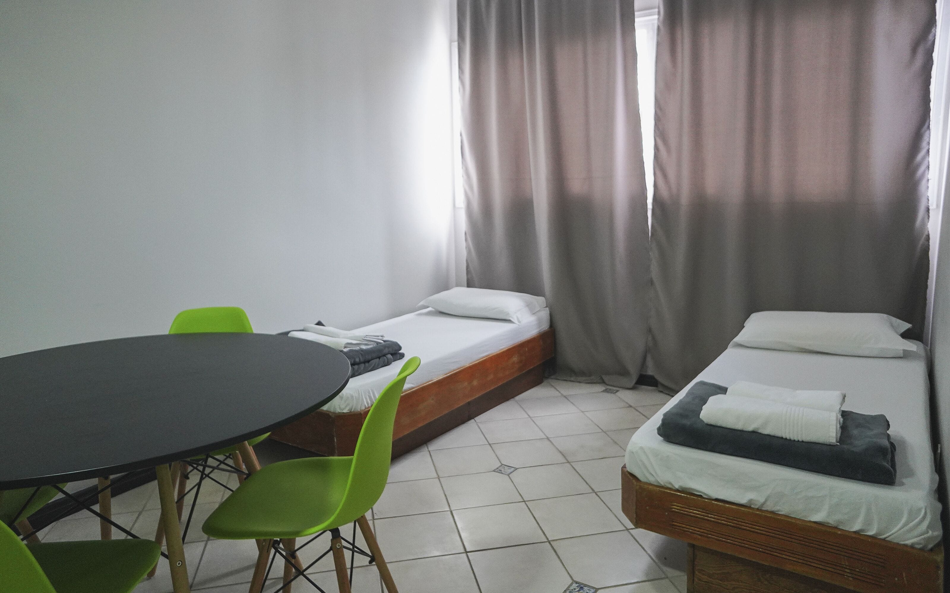 A room with a bed, a table, and a chair.