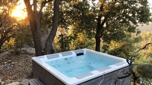 A hot tub in a natural setting with trees and a stone pathway. - Modern and rustic cabin in a beautiful secluded setting (Idyllwild-Pine Cove)