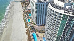 A high-rise hotel with a pool area and beach access. - Remodeled 5th Floor Condo All Tile Near Boardwalk! (Myrtle Beach)