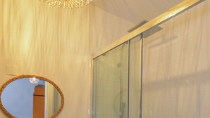 A bathroom with a wooden vanity, a round mirror, a white sink, and a glass-enclosed shower. - !!! COZY APARTMENT 500 FROM THE PALAIS DES PAPES !!! (Avignon)