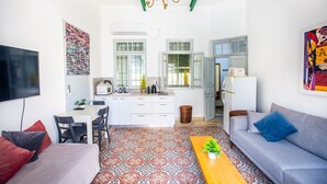Un espace de vie compact comprenant une cuisine, un coin repas et un coin salon.