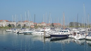 A marina with numerous boats docked, surrounded by buildings with red roofs. - 3 bedroom stunning home in Wemeldinge (Wemeldinge)