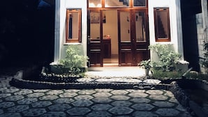 A two-story building with a balcony, large windows, and a stone-paved entrance. - Lagi 1001 Nights Hotel (La Gi)