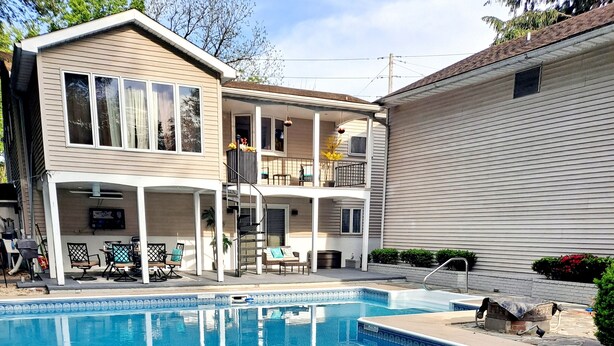A swimming pool with a covered patio area, a two-story house, and a small shed. - Close to lot of shopping areas, eateries, bars and more. Ideal for monthly stays (Lancaster)