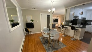 A modern kitchen with white cabinets, a black countertop, and a built-in oven. - Close to lot of shopping areas, eateries, bars and more. Ideal for monthly stays (Lancaster)