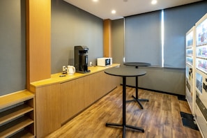 A compact kitchen with a coffee maker, microwave, and a small table. - R9 Hostel Tochigi Ekimae - Man Only (Tochigi)