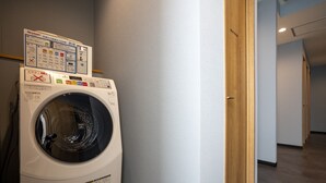 Un cuarto de lavandería con lavadora y panel de control.