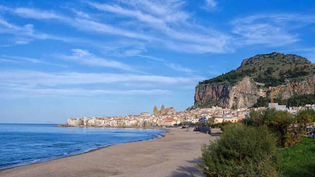A coastal town with a prominent cliff and a beach.