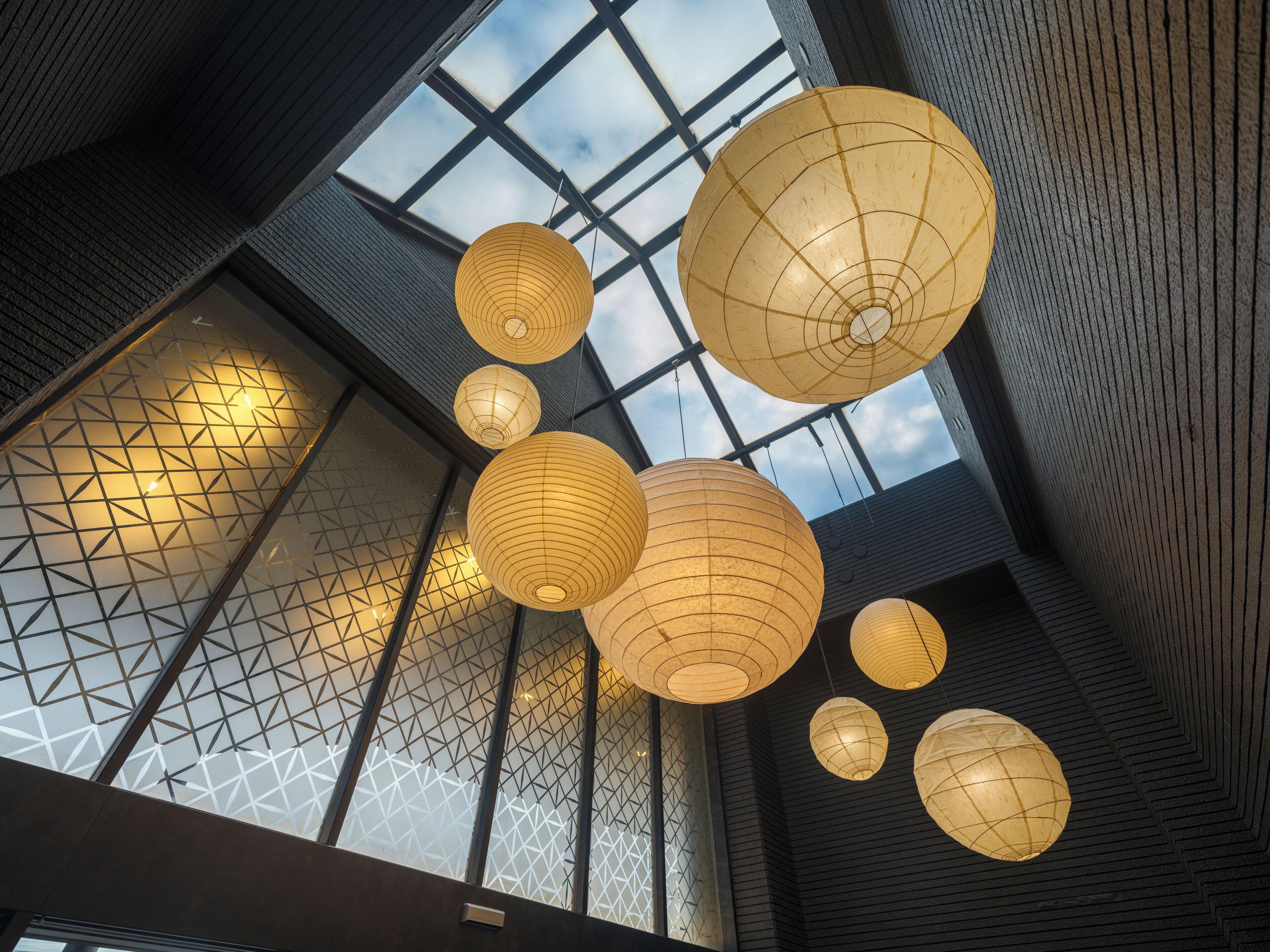 A modern interior with geometric patterned walls and large windows.