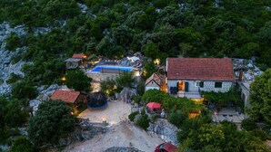 An aerial view of a rustic property with stone buildings, a swimming pool, and surrounding greenery. - Amazing home in Ploce with sauna (Ploce)
