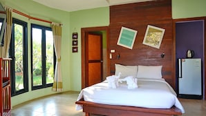 A hotel room with a wooden bed, a refrigerator, a wooden wardrobe, and a window with curtains. - The Breath Chiangdao (Chiang Dao)